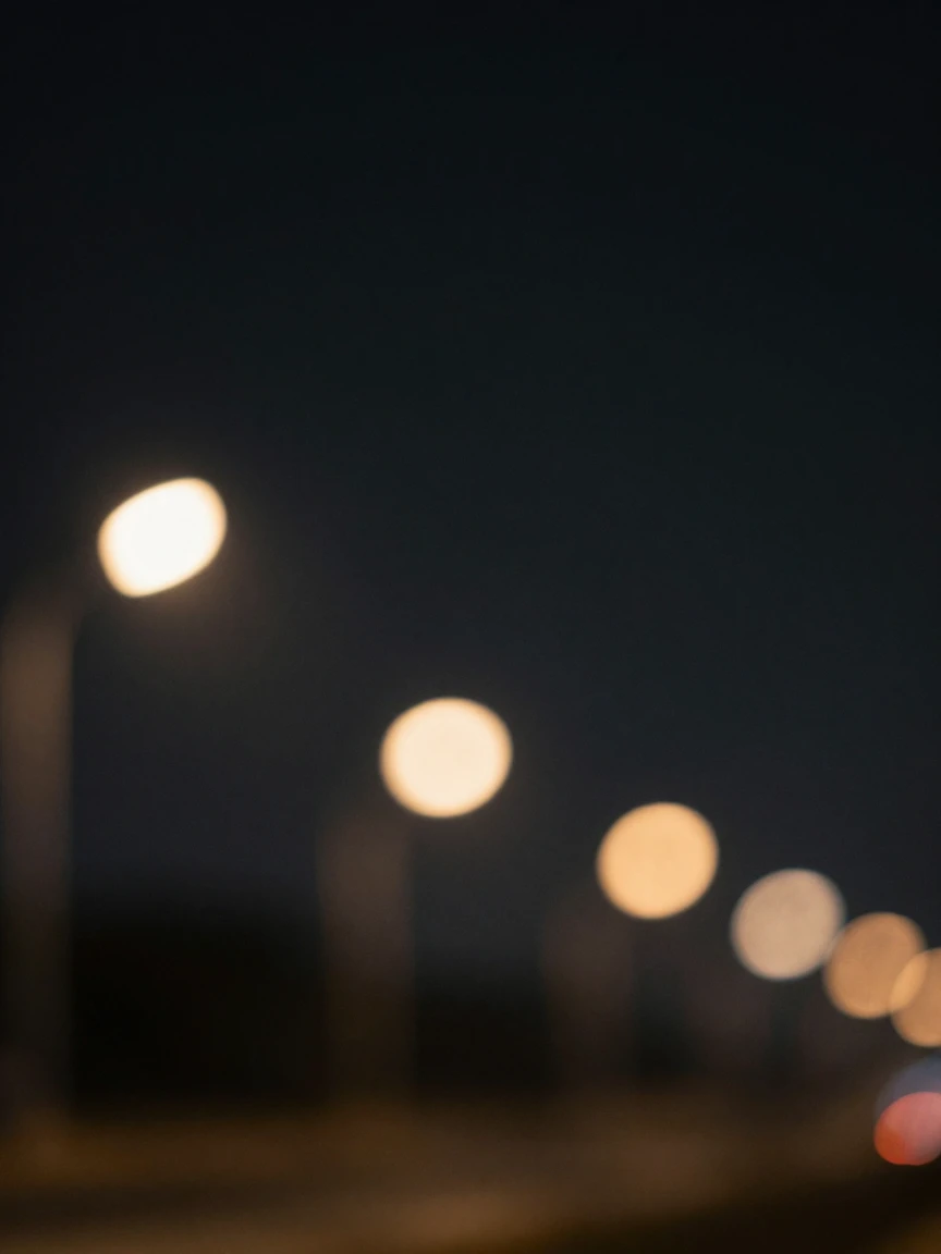 A minimalist background of soft blurred city lights at night.